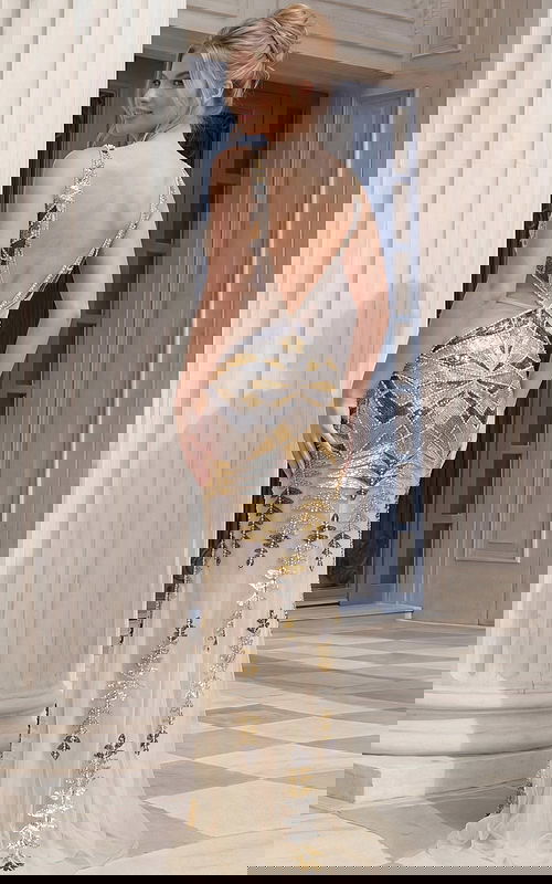 Back view of beaded sleeveless gown with deep V open back and floor length design