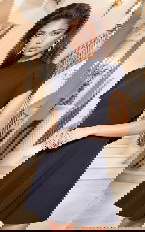 Front view of elegant short black dress with cap sleeves and flared skirt