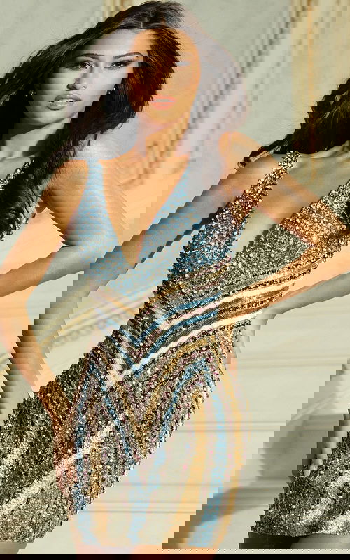 Model wearing multicolor beaded mini dress with deep V neckline