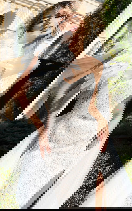 Statement white gown with textured flower accent and shimmering fabric