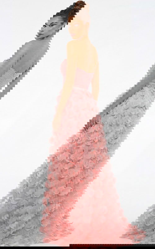 Back view of strapless gown with ruched bodice, beaded waist, and flowing skirt covered in soft circular appliqués